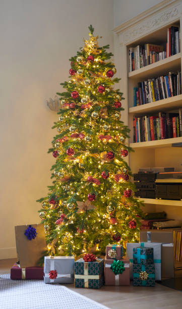 istock Illuminated Christmas tree with Christmas packages, set in the apartment 1281880988