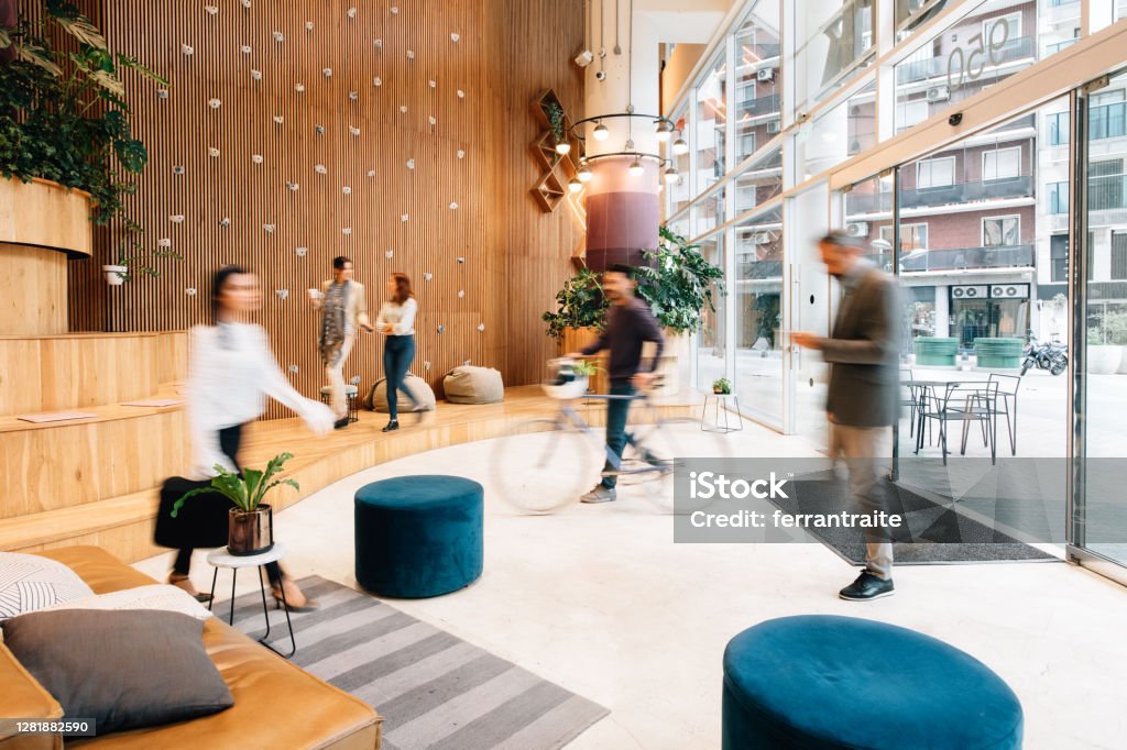 Commuters arriving to office lobby Office Stock Photo