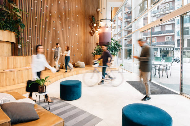 Commuters arriving to office lobby Commuters arriving to office lobby responsible business stock pictures, royalty-free photos & images