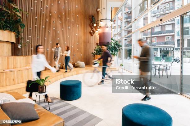 Commuters Arriving To Office Lobby Stock Photo - Download Image Now - Office, Lobby, Modern