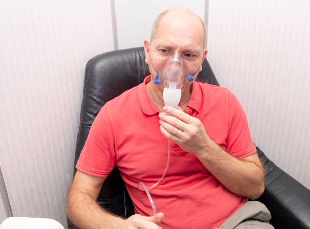 istock A Caucasian man, 40-50 years old, does inhalation with a nebulizer. 1281885624