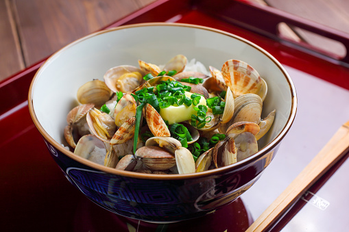 Rice that is steamed with clams, sprinkled over rice, and seasoned with soy sauce and butter.