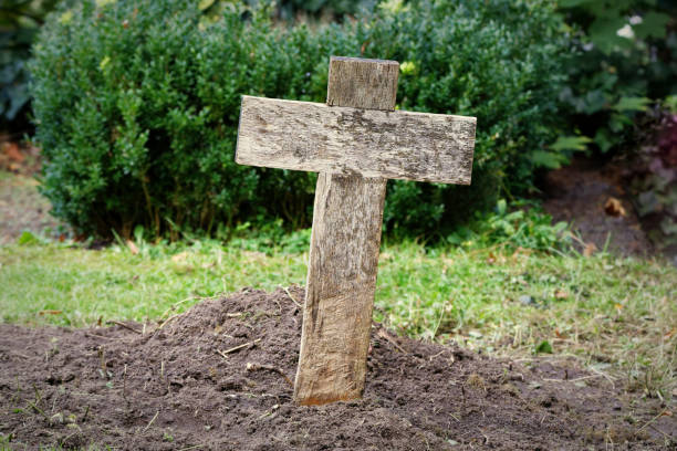 simple cheap wooden cross on a paupers grave