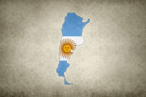 Grunge map of Argentina with its flag printed within its border on an old paper.