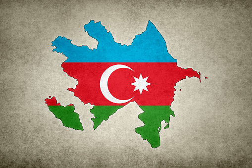 Grunge map of Azerbaijan with its flag printed within its border on an old paper.