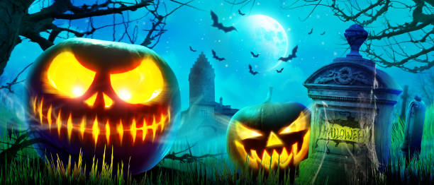 istock Halloween pumpkin face with burning fire inside in the graveyard. 1281894289