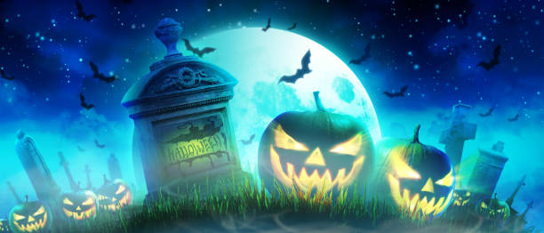 istock Halloween pumpkin face with burning fire inside in the graveyard. 1281894298