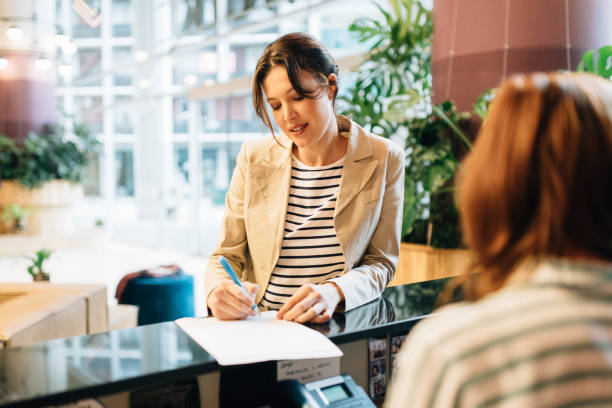istock Businesswoman checking in at Hotel Reception 1281894374