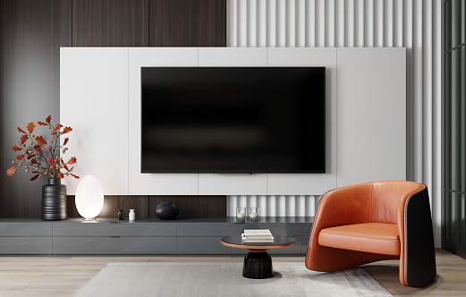 Modern and minimalist living room with 8K TV flat screen wall-mounted. Modern armchair. 3d renderings.