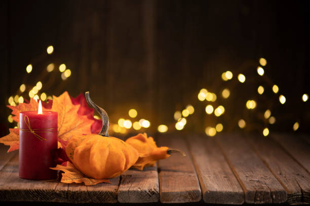 istock Thanksgiving decoration with pumpkins and greeting card on illuminated background and a rustic wooden table 1281896532