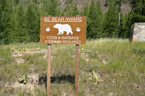 Sign - be bear aware - food and garbage storage required, in grizzly area