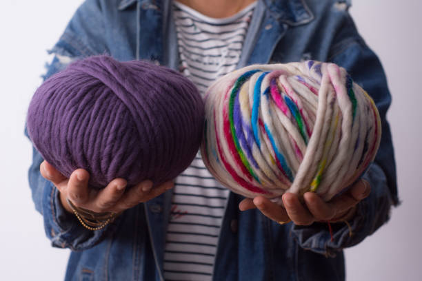 istock Woman holding colored wool balls. 1281898747