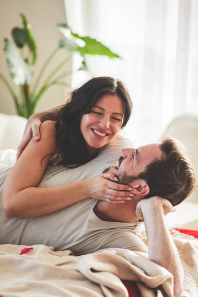istock Couple having a cuddle in bed in the morning 1281899572
