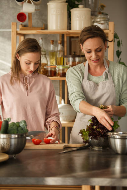 istock Young woman preparing lunch with her mother 1281899626