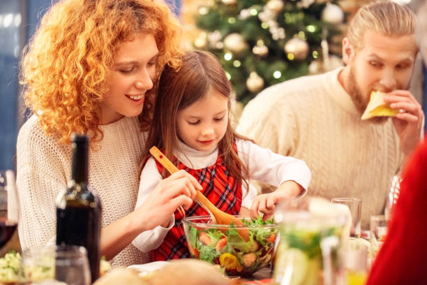 istock Family sitting behind table with fresh salad 1281899877