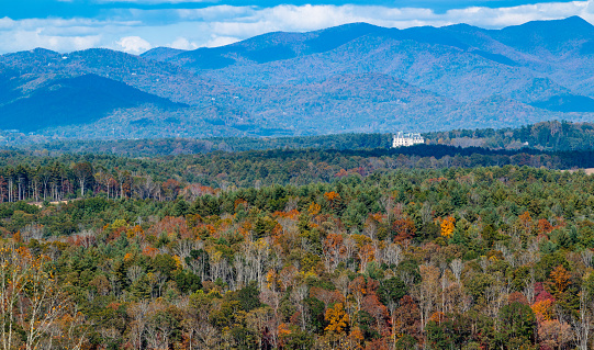 View of the backside of Biltmore House from the Blue Ridge Parkway during Autumn leaf season.