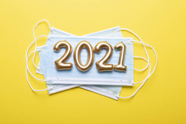 istock Happy new year 2021 with face mask on yellow 1281903732