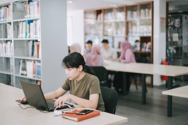 istock asian university female student studying in library 1281913419