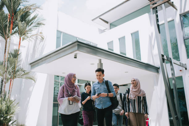 istock group of asian university student walking out from education building talking 1281913441