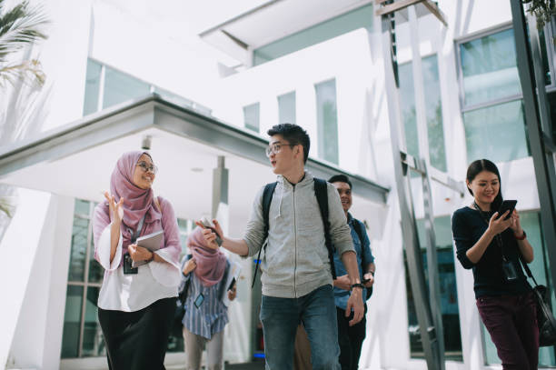 istock group of asian university student walking out from education building talking 1281913468