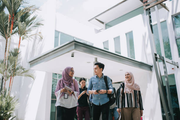 istock group of asian university student walking out from education building talking 1281913469