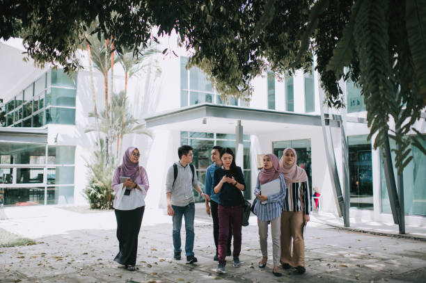 istock group of asian university student walking out from education building talking 1281913478