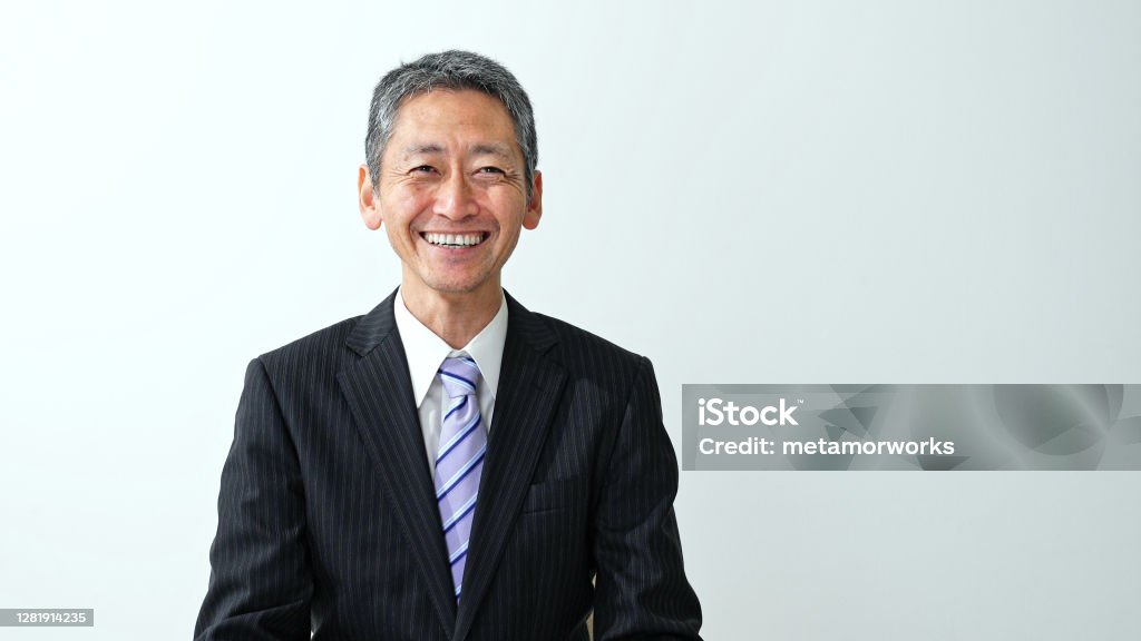 Smiling middle aged asian businessman. Japanese Ethnicity Stock Photo