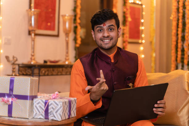 istock Young man ethnic wear using laptop on festival day 1281915215