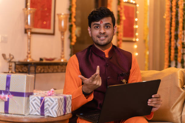 istock Young man ethnic wear using laptop on festival day 1281915236