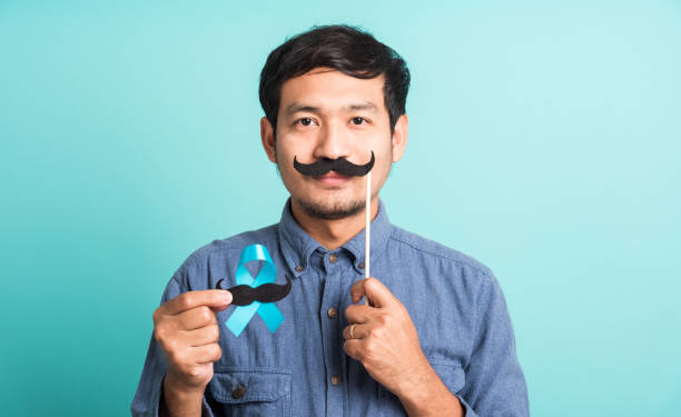 istock handsome man posing he holding a light blue ribbon and mustache 1281919347