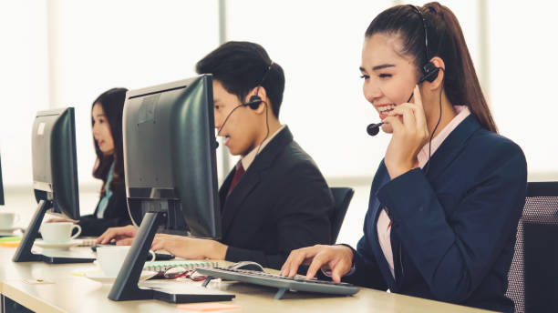 istock Business people wearing headset working in office 1281920489