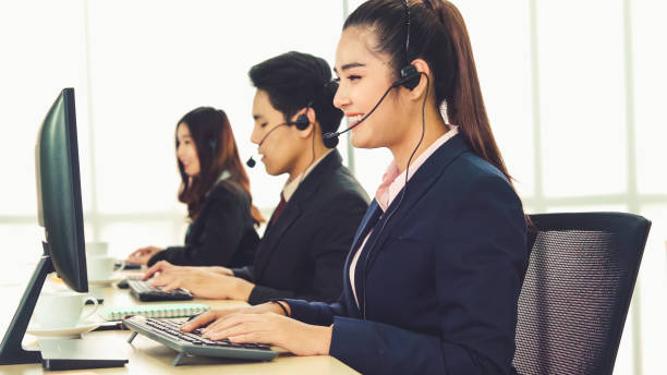 istock Business people wearing headset working in office 1281920653