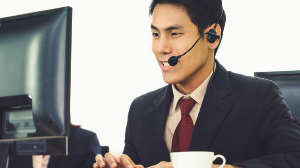 istock Business people wearing headset working in office 1281921429