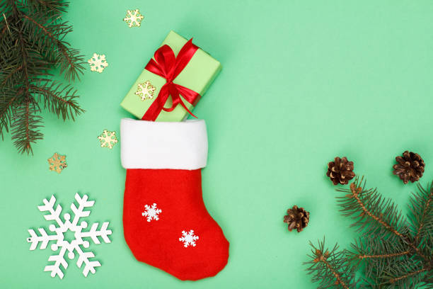 istock Santa's boot, gift box, fir tree branches with cones and toy snowflakes 1281922605