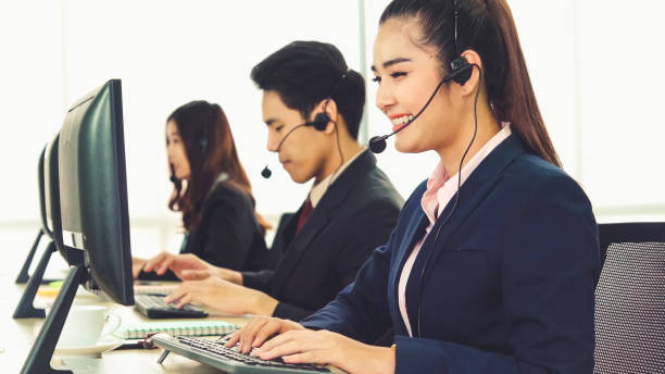 istock Business people wearing headset working in office 1281922871