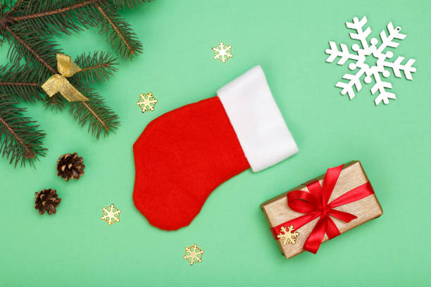 istock Santa's boot, gift box, fir tree branches with cones and snowflakes 1281923130