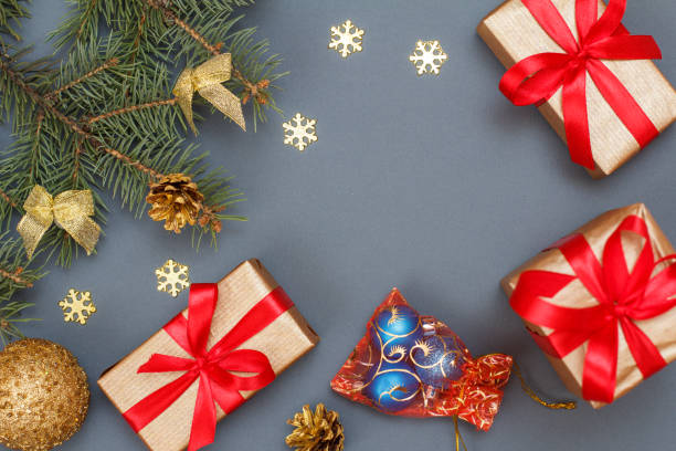 istock Gift boxes, fir tree branches with cones and toys on gray background 1281923161