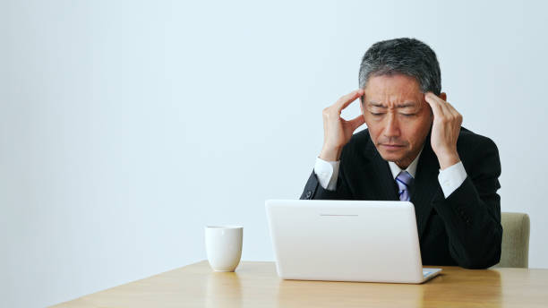 istock Depressed middle aged businessman with a laptop computer. 1281924161