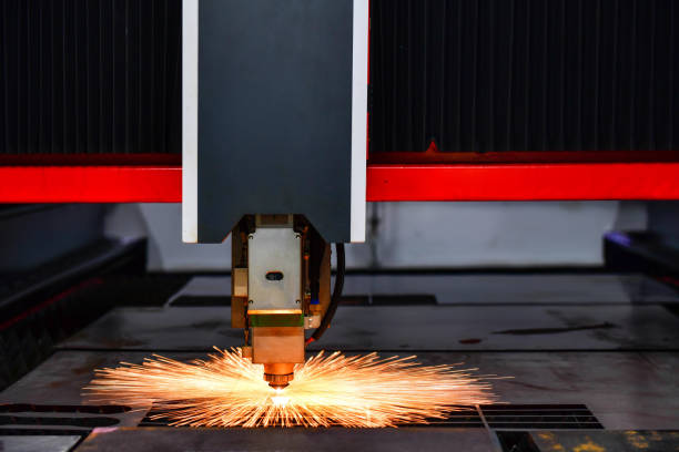 istock Raytools laser cut head machine while cutting the sheet metal with the sparking light in factory 1281924701