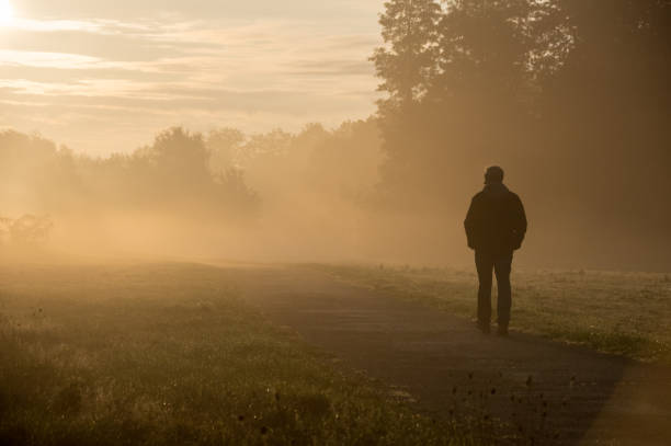 Brunssum, the Netherlands, - October 192, 2020. Man walking in the morning dew on a autumn day in October