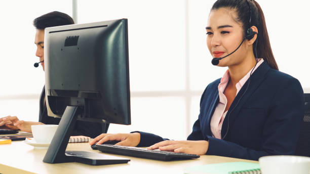 istock Business people wearing headset working in office 1281924972
