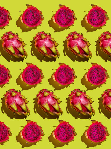 istock Dragon Fruit Pattern - Pitahaya Cut into pieces and whole on a yellow background 1281926438
