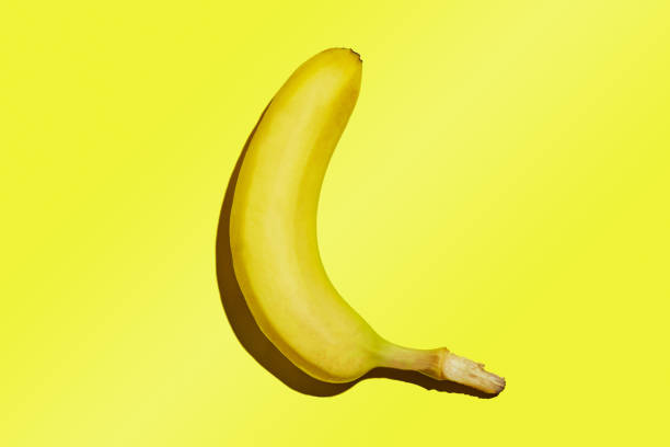 istock A whole ripe banana isolated on a yellow gradient background 1281926481