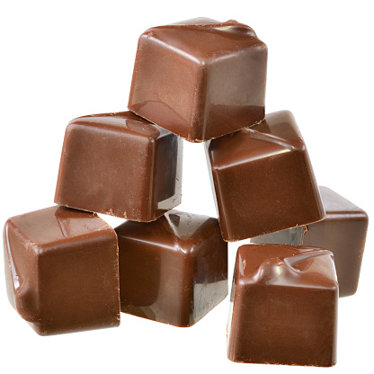 Cubes of chocolate candy isolated on a white background.