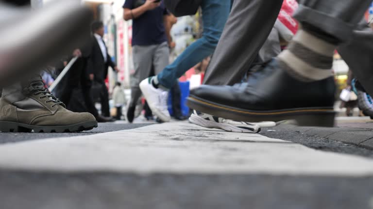 Close-up of Leg People walking on the crosswalk