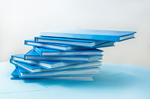 blue textbooks on a blue background, horizontal