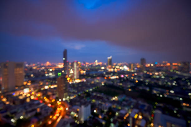 Close-up of the streetlight at the sunset with buildings in the background, City lamppost in the street with cityscape background. Cityscape and downtown scene.