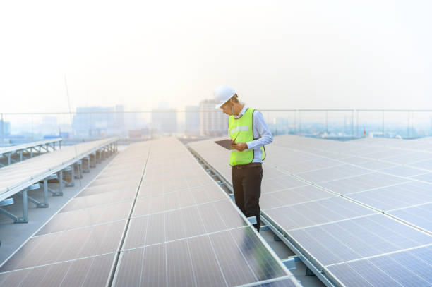 engineer are using laptop is checking the solar panel. - solar power station solar panel energy electrician imagens e fotografias de stock