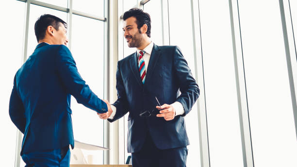 istock Business people handshake in corporate office 1281930277