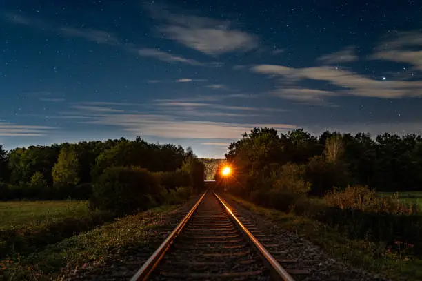 Starry sky over the landscape with train tracks